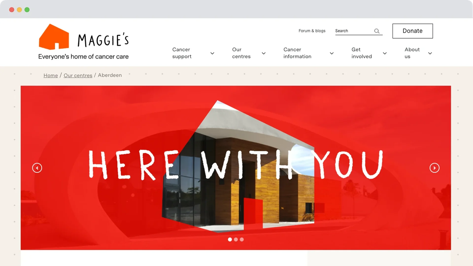 Homepage of Maggie’s Centre Aberdeen with a bold red overlay featuring the building and handwritten-style text reading ‘Here With You’.