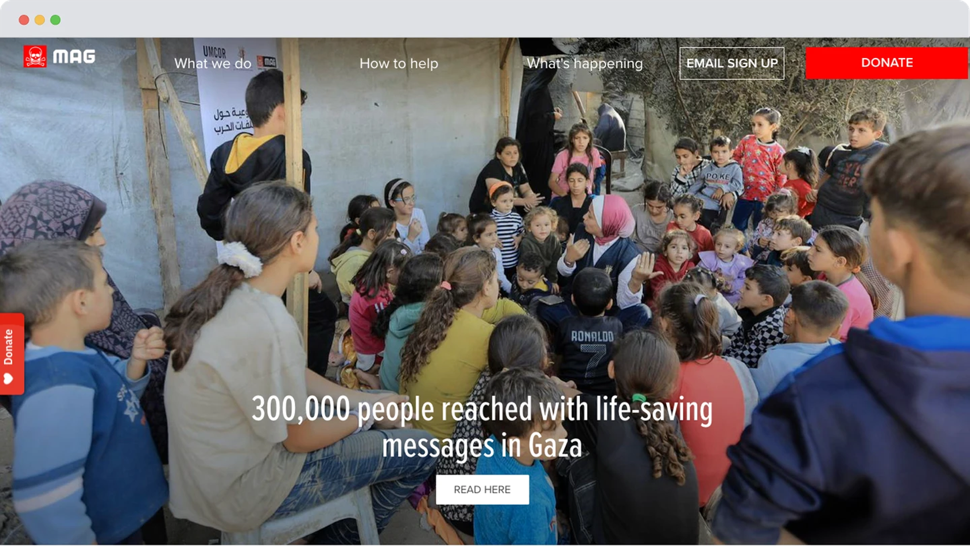 A large group of children gathered around a woman sharing information, with some kids raising hands and listening attentively in an outdoor setting in Gaza.