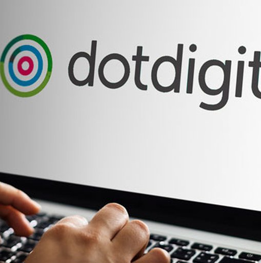 Person using a laptop displaying the Dotdigital logo on the screen.