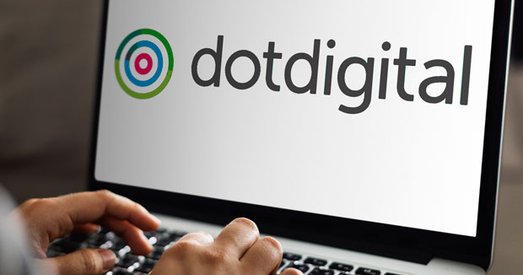 Person using a laptop displaying the Dotdigital logo on the screen.